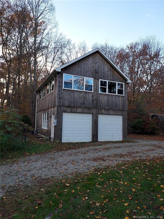 a front view of house with yard and trees