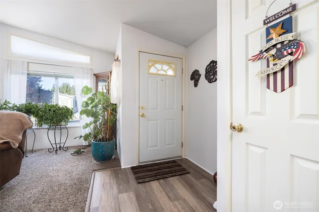 a view of an entryway with wooden floor