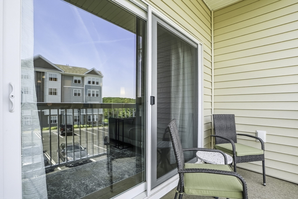 2 Codman Way, Unit 2203 Westborough, MA 01581 - Photo 23 of 36 a balcony with table and chairs