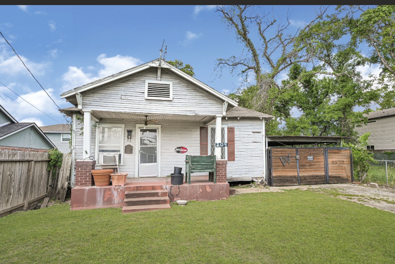 a front view of house with yard and outdoor seating