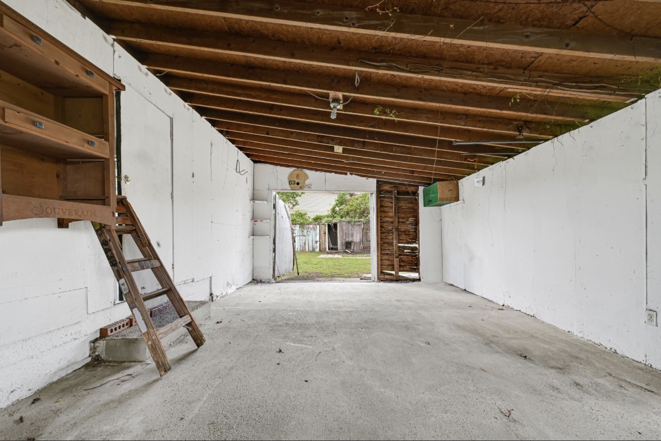 209 Frawley Street Houston, TX 77009 - Photo 18 of 21 a view of an empty room with stairs and a floor to ceiling window