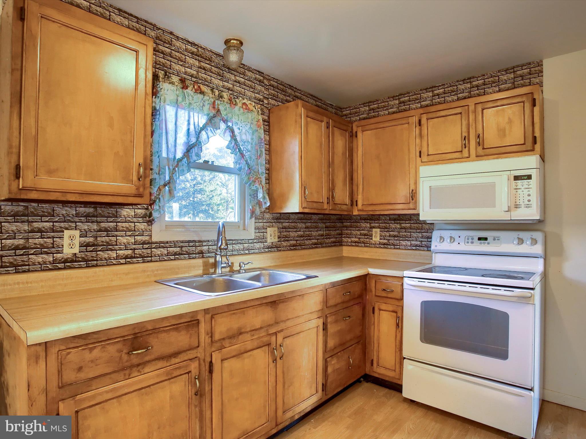 151 Oak Flat Road Newville, PA 17241 - Photo 11 of 33 a kitchen with cabinets appliances a sink and a window