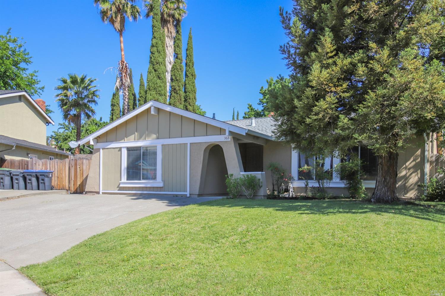 a front view of house with yard and trees