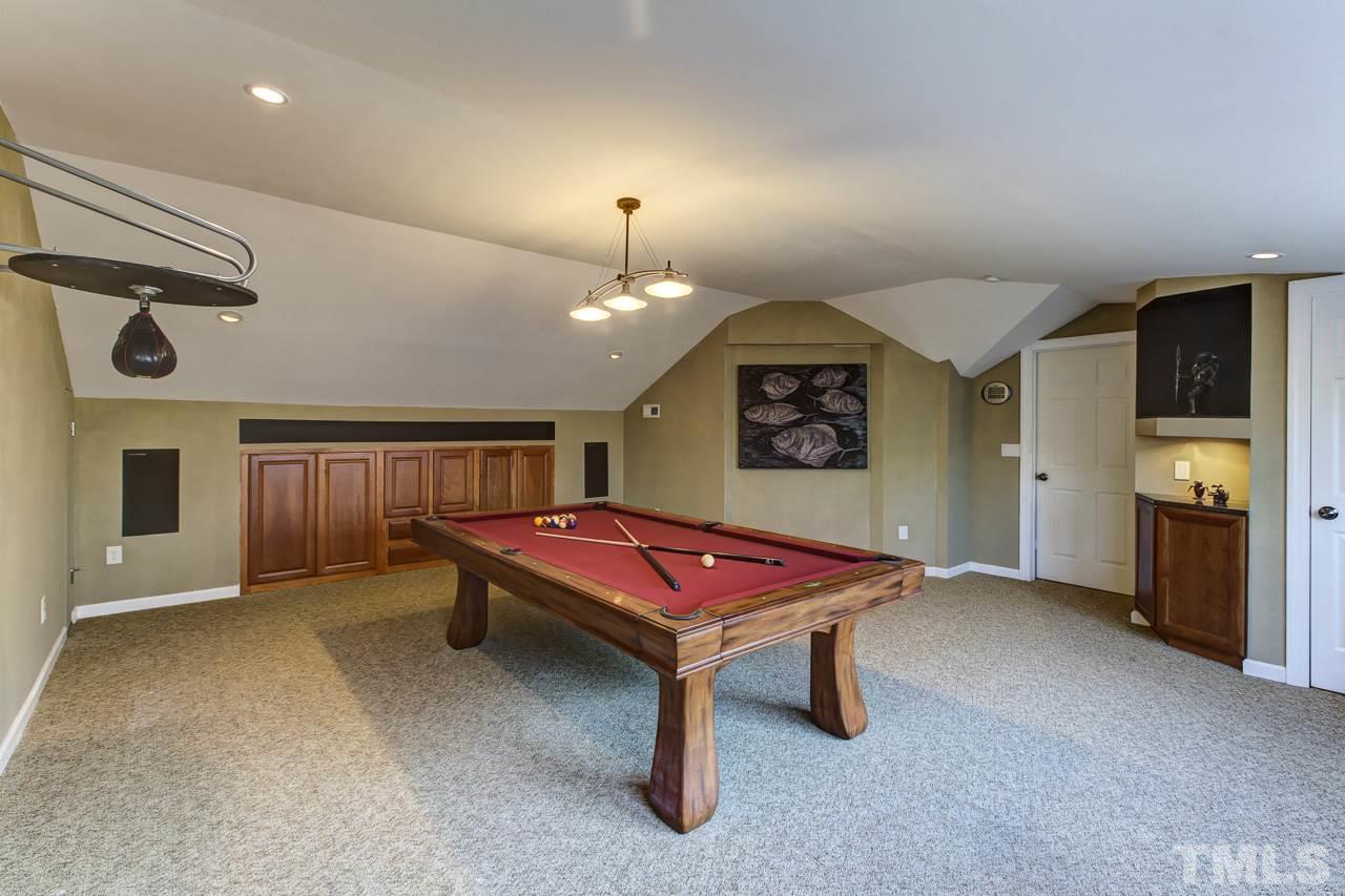12312 Galway Drive Raleigh, NC 27613 - Photo 22 of 25 The bonus room is very spacious, has a wall of windows, and built-in media cabinets.