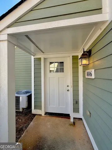 a view of a livingroom with wooden floor and a window