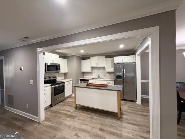a kitchen with cabinets and stainless steel appliances