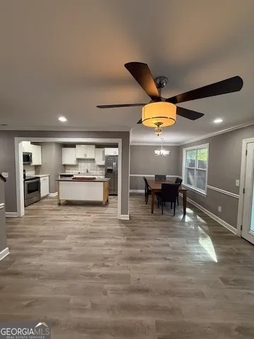 a living room with furniture and kitchen view