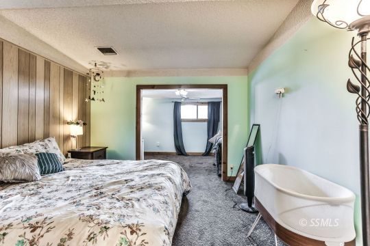 541 South Allen Street Ridgecrest, CA 93555 - Photo 24 of 41 a bedroom with a bed couch and mirror