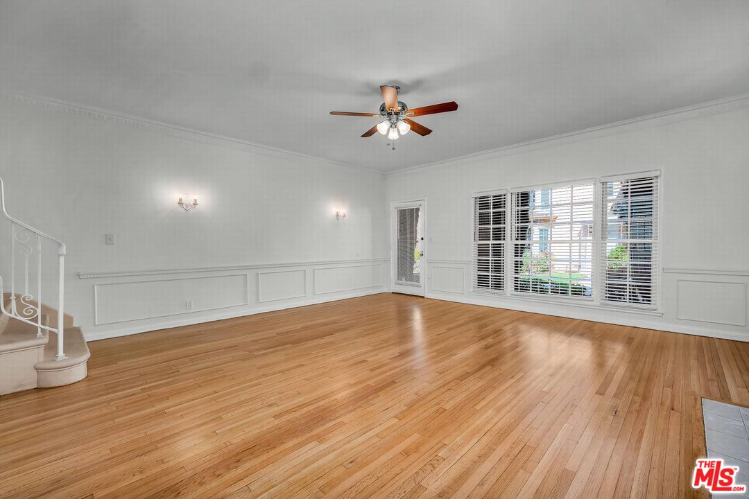 614 Midvale Avenue Los Angeles, CA 90024 - Photo 12 of 18 a view of empty room with wooden floor and fan