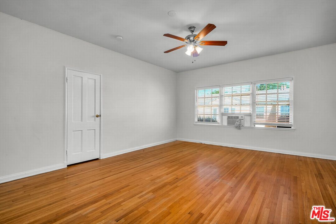 614 Midvale Avenue Los Angeles, CA 90024 - Photo 6 of 18 a view of empty room with wooden floor and fan