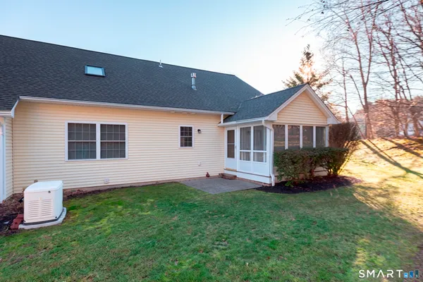 a front view of a house with a garden and yard