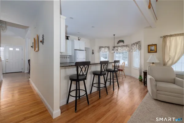 a view of a dining room with furniture and wooden floor