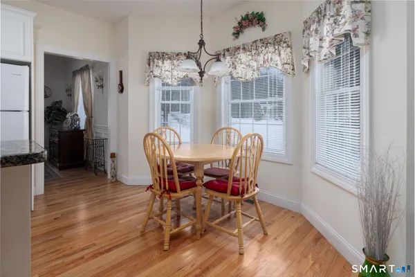 a view of a dining room with furniture wooden floor and chandelier