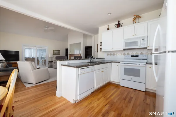 a kitchen with a white cabinets and white appliances