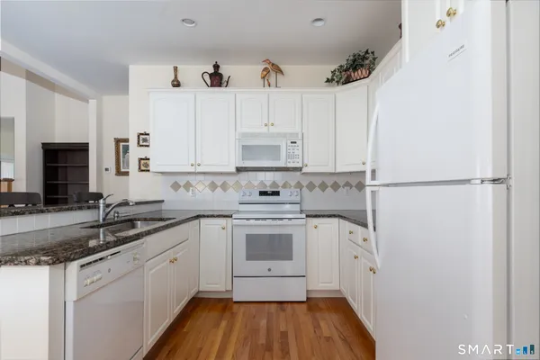 a kitchen with a sink cabinets stainless steel appliances and a counter space