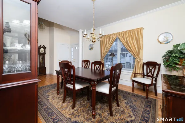 a view of a dining room with furniture window and wooden floor
