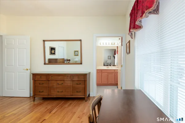 a view of a room with wooden floor and cabinet
