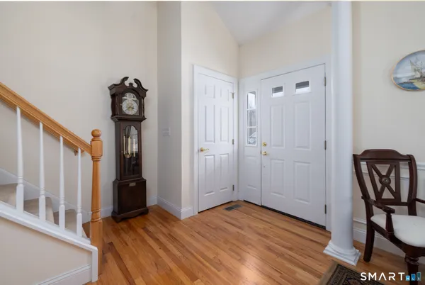 a view of an entryway with wooden floor