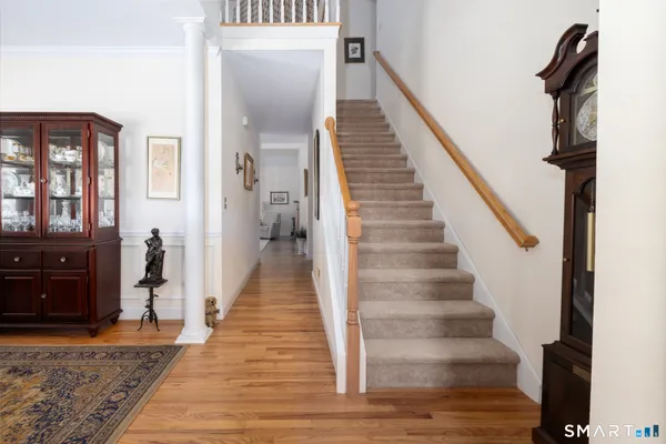 a view of an entryway with wooden floor and staircase