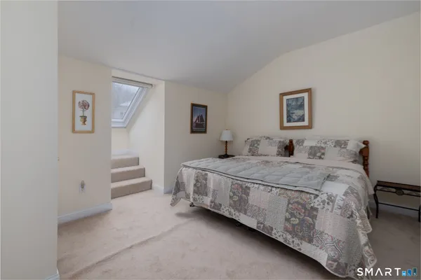 a bedroom with a bed and a wall painting