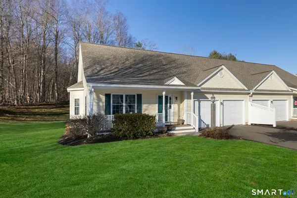 a front view of a house with a yard and porch