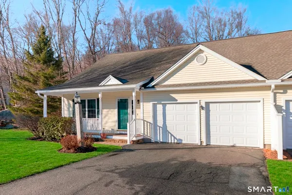 a front view of a house with a garden and plants