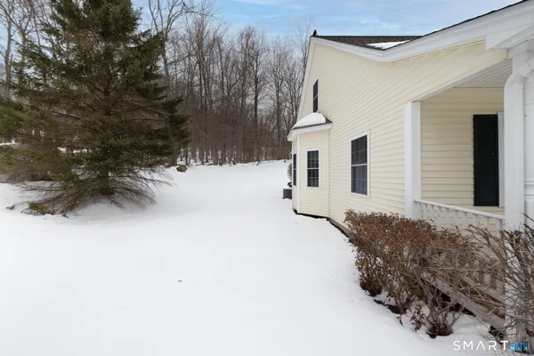 a view of a house with a snow in the yard