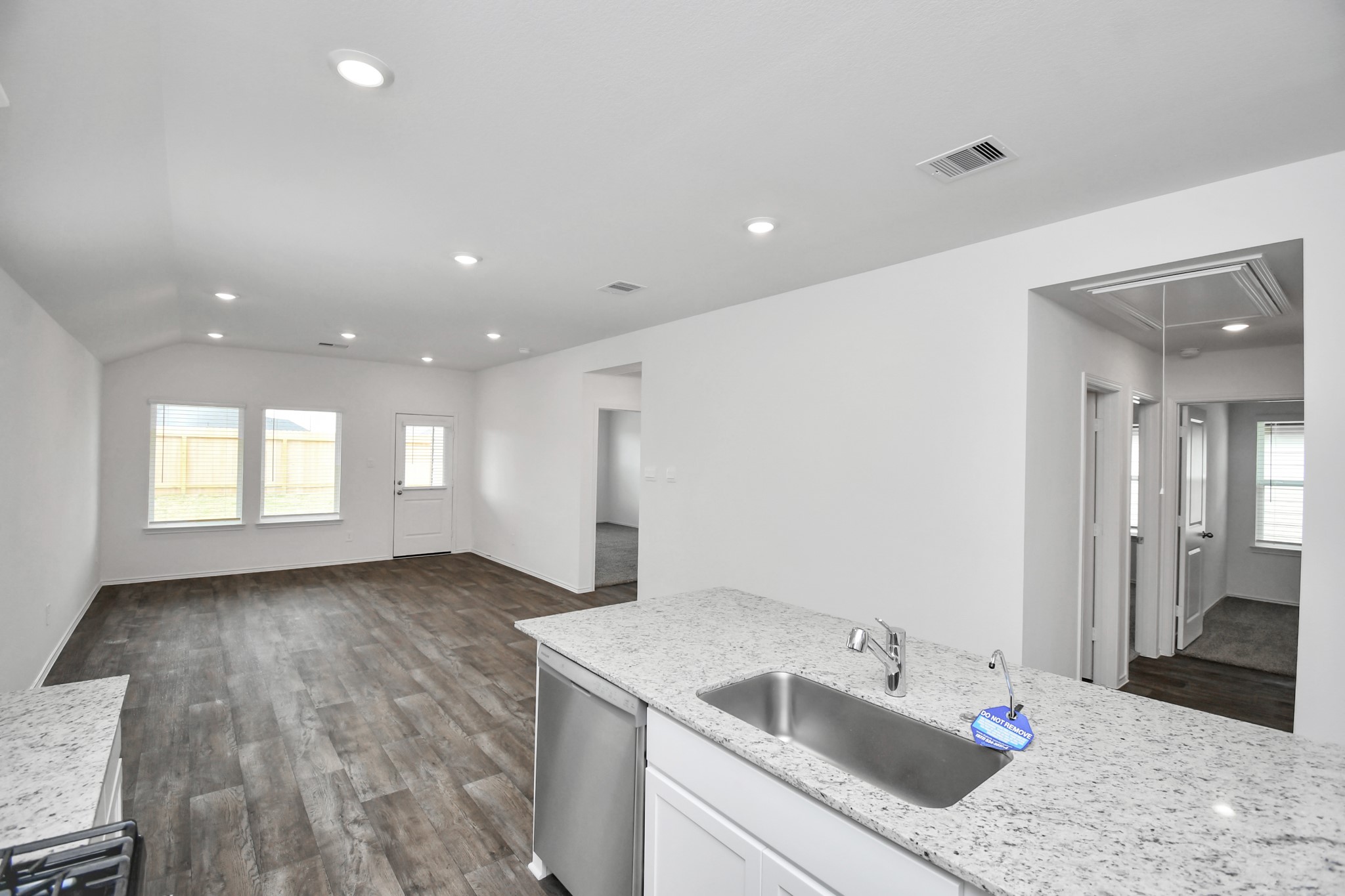 3822 Zoeys Way Fulshear, TX 77423 - Photo 13 of 37 a kitchen with a sink dishwasher and a refrigerator with wooden floor