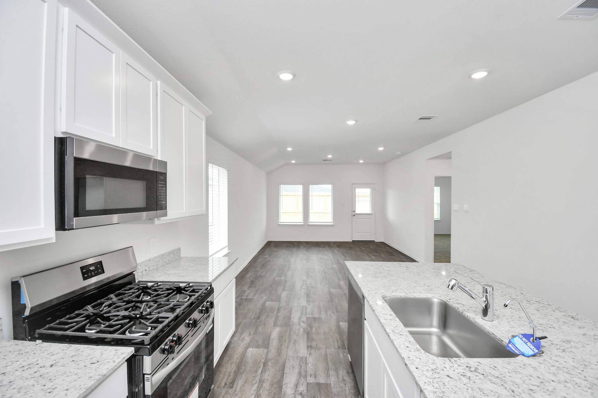 3822 Zoeys Way Fulshear, TX 77423 - Photo 16 of 37 a kitchen with a sink a stove and cabinets