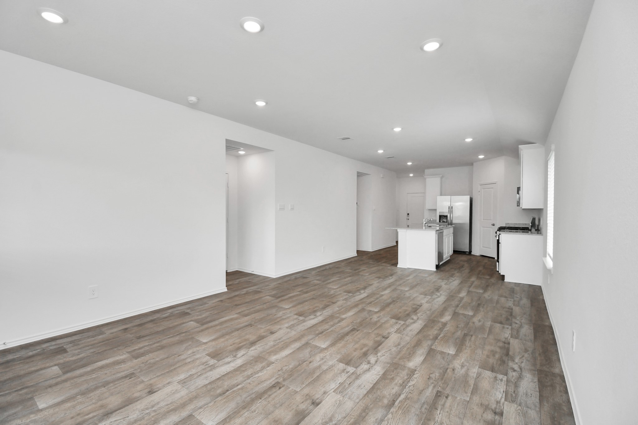 3822 Zoeys Way Fulshear, TX 77423 - Photo 18 of 37 a view of a kitchen with a sink and a refrigerator