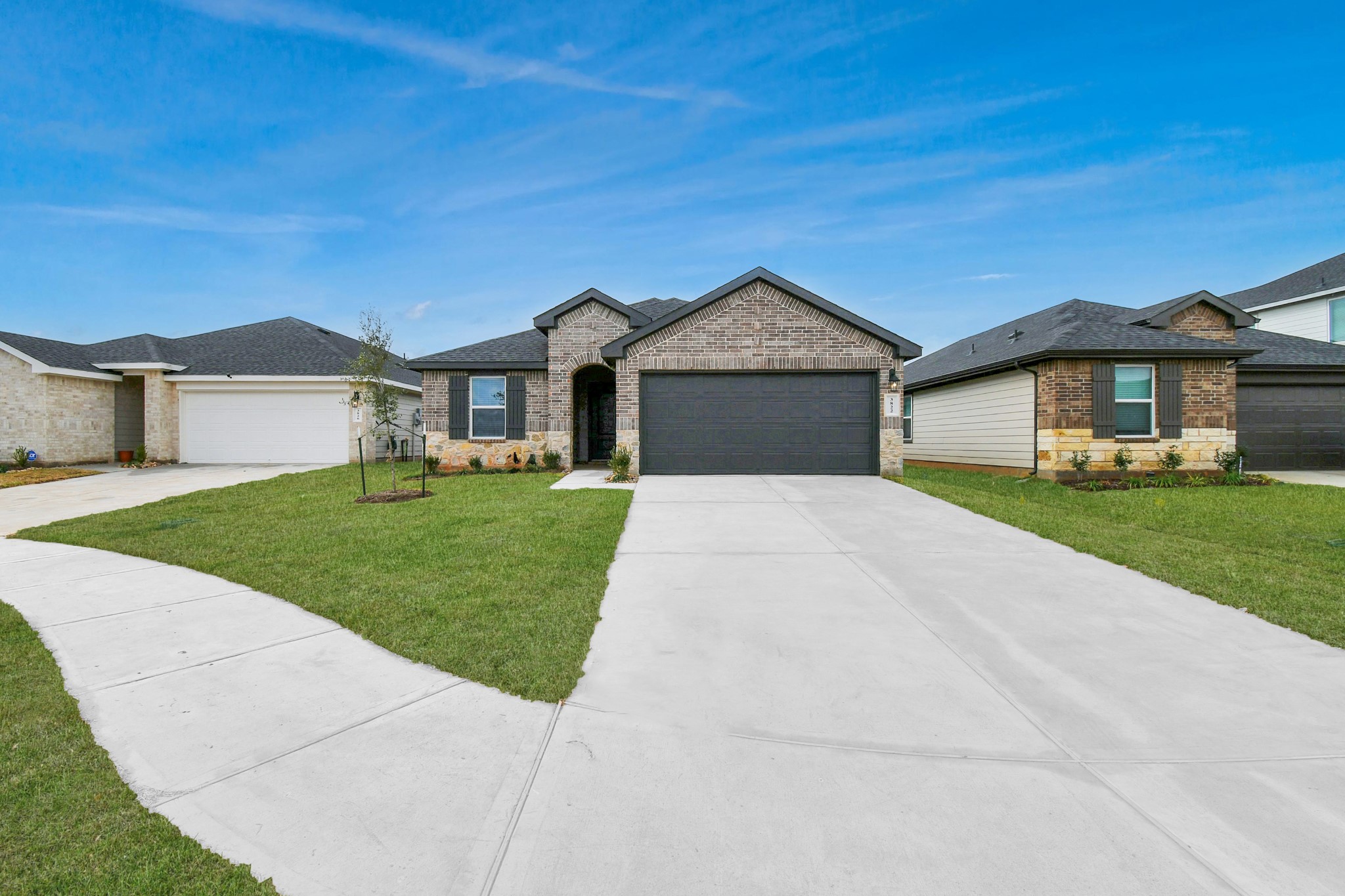 3822 Zoeys Way Fulshear, TX 77423 - Photo 2 of 37 a front view of a house with a yard and garage