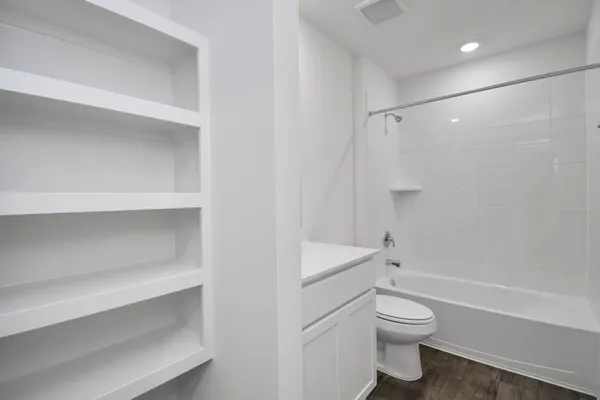 a bathroom with a toilet and a shower