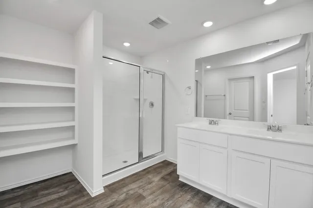 a bathroom with a double vanity sink and mirror
