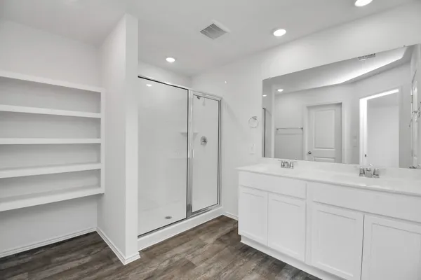 a bathroom with a double vanity sink and mirror