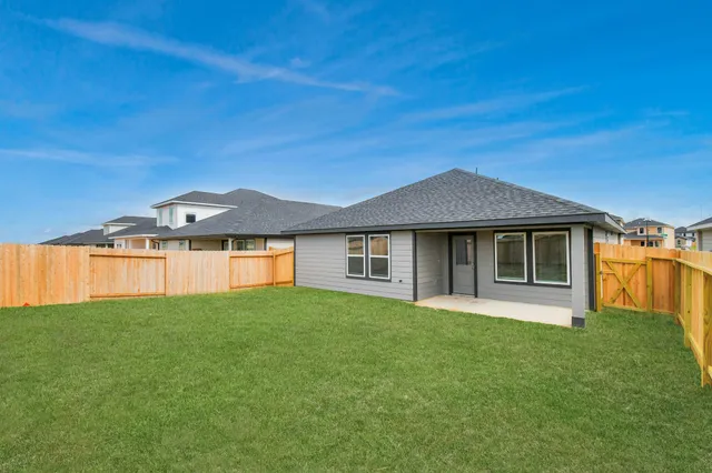 a front view of a house with yard and green space