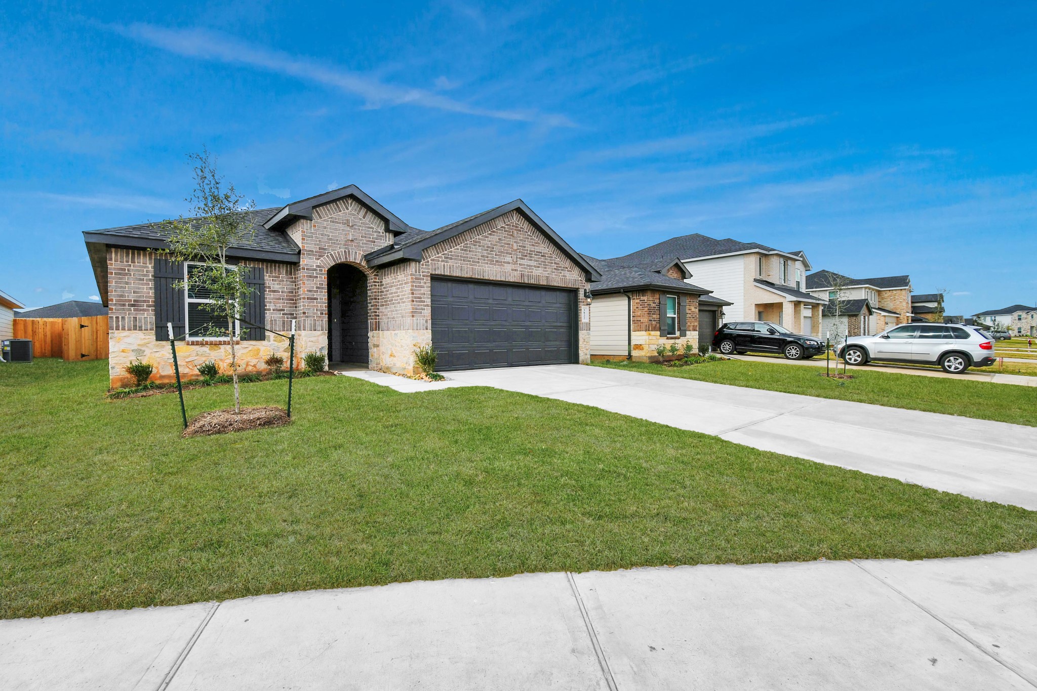 3822 Zoeys Way Fulshear, TX 77423 - Photo 4 of 37 a front view of a house with a yard