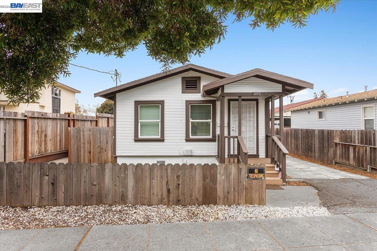 409 Foothill Boulevard San Leandro, CA 94577 - Photo 1 of 1 a view of a house with wooden fence next to a road