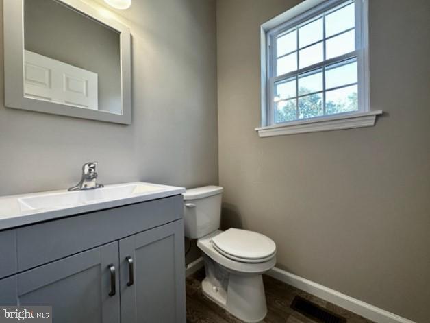 1245 Old Lake Road Newfield, NJ 08344 - Photo 17 of 34 a bathroom with a toilet a sink and mirror