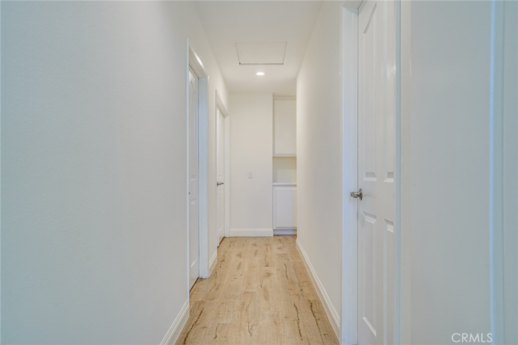 49 East Yale Loop, Unit 26 Irvine, CA 92604 - Photo 19 of 63 a view of a hallway with wooden floor