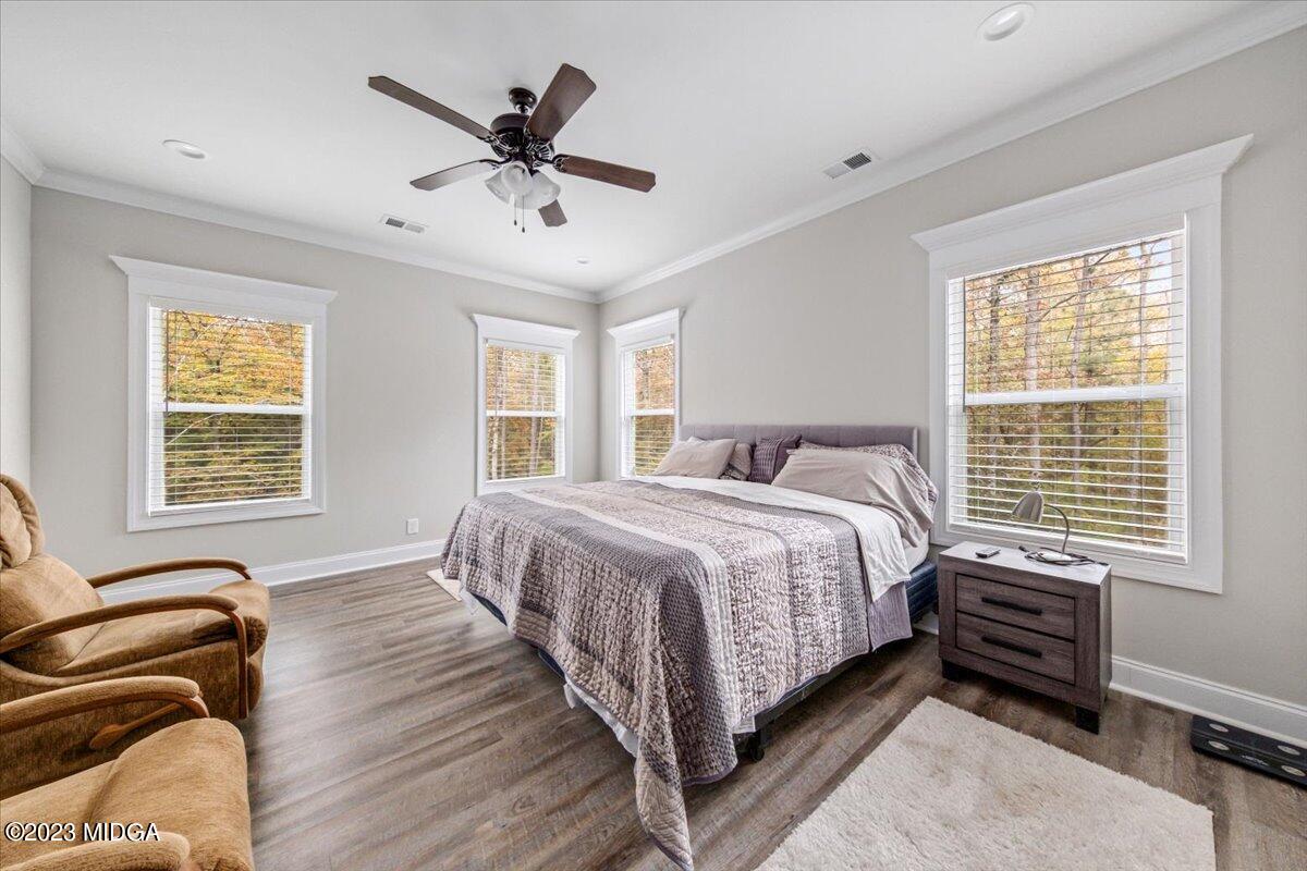208 Carters Way Forsyth, GA 31029 - Photo 12 of 22 a bedroom with a bed and windows