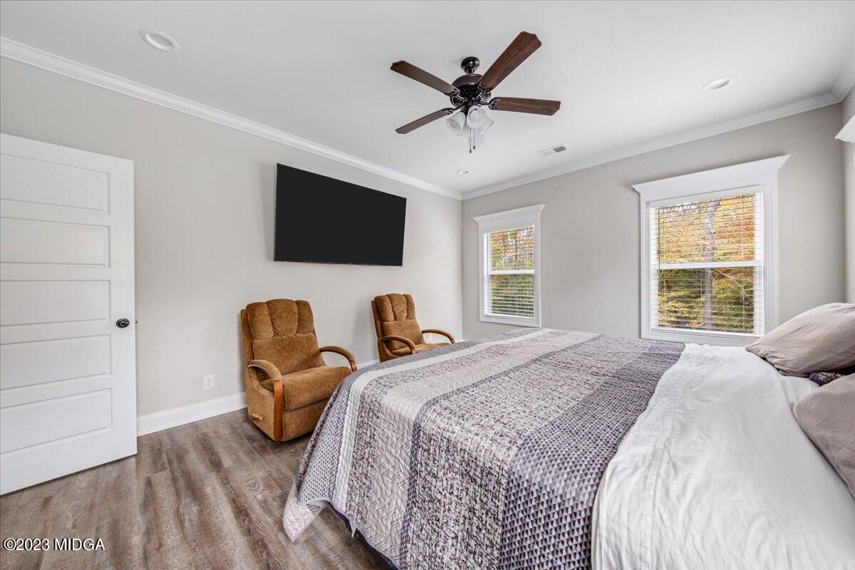 208 Carters Way Forsyth, GA 31029 - Photo 13 of 22 a bedroom with a bed a flat screen tv and a couch