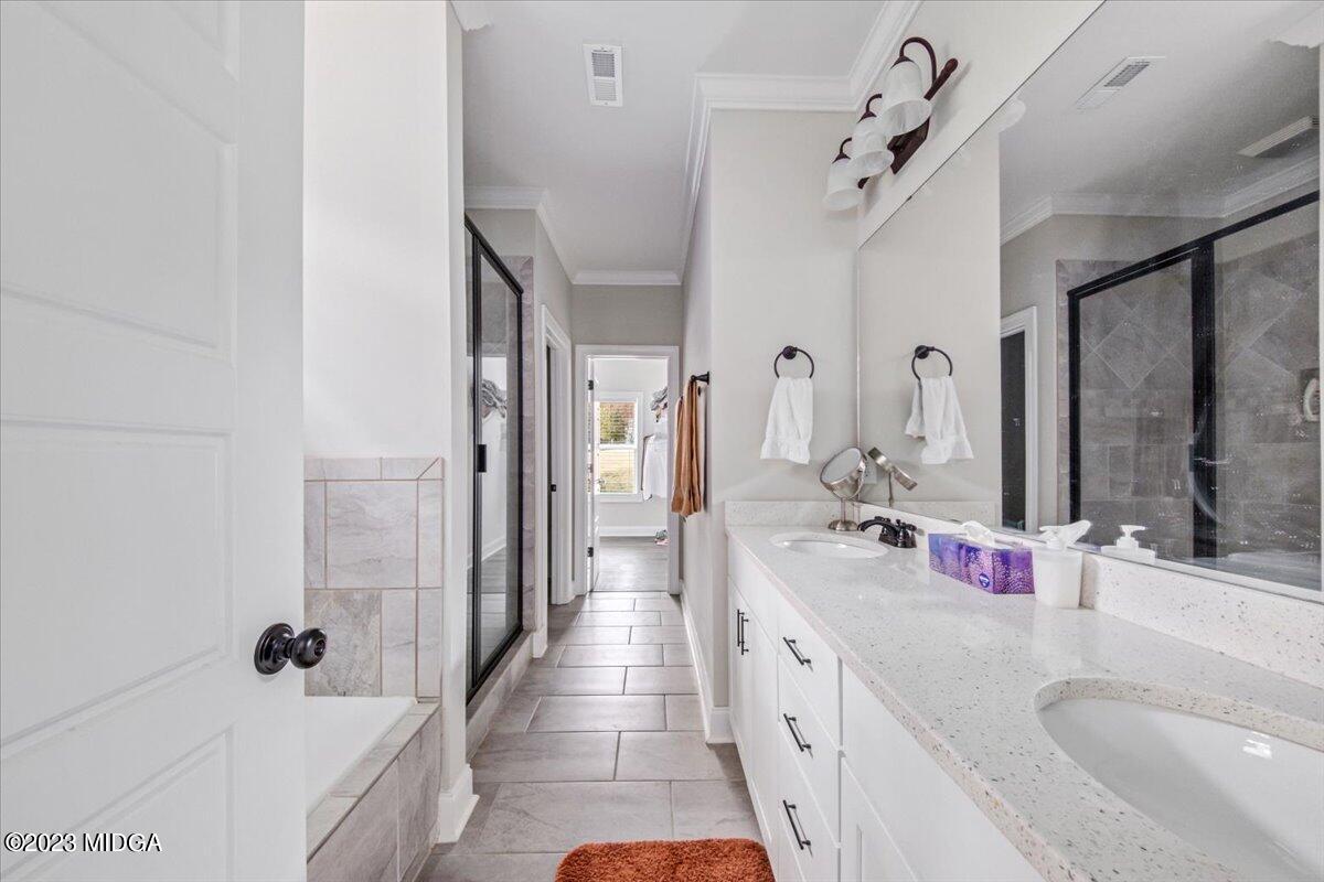 208 Carters Way Forsyth, GA 31029 - Photo 14 of 22 a bathroom with a granite countertop double vanity sink a mirror and shower