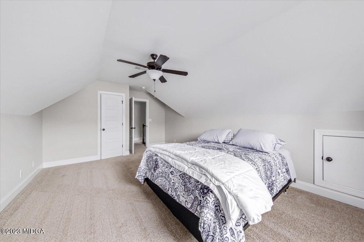 208 Carters Way Forsyth, GA 31029 - Photo 20 of 22 a bedroom with a bed and a ceiling fan