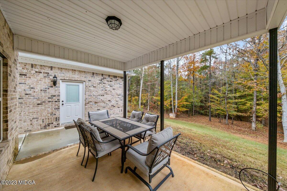 208 Carters Way Forsyth, GA 31029 - Photo 21 of 22 a dining room with furniture and a floor to ceiling window