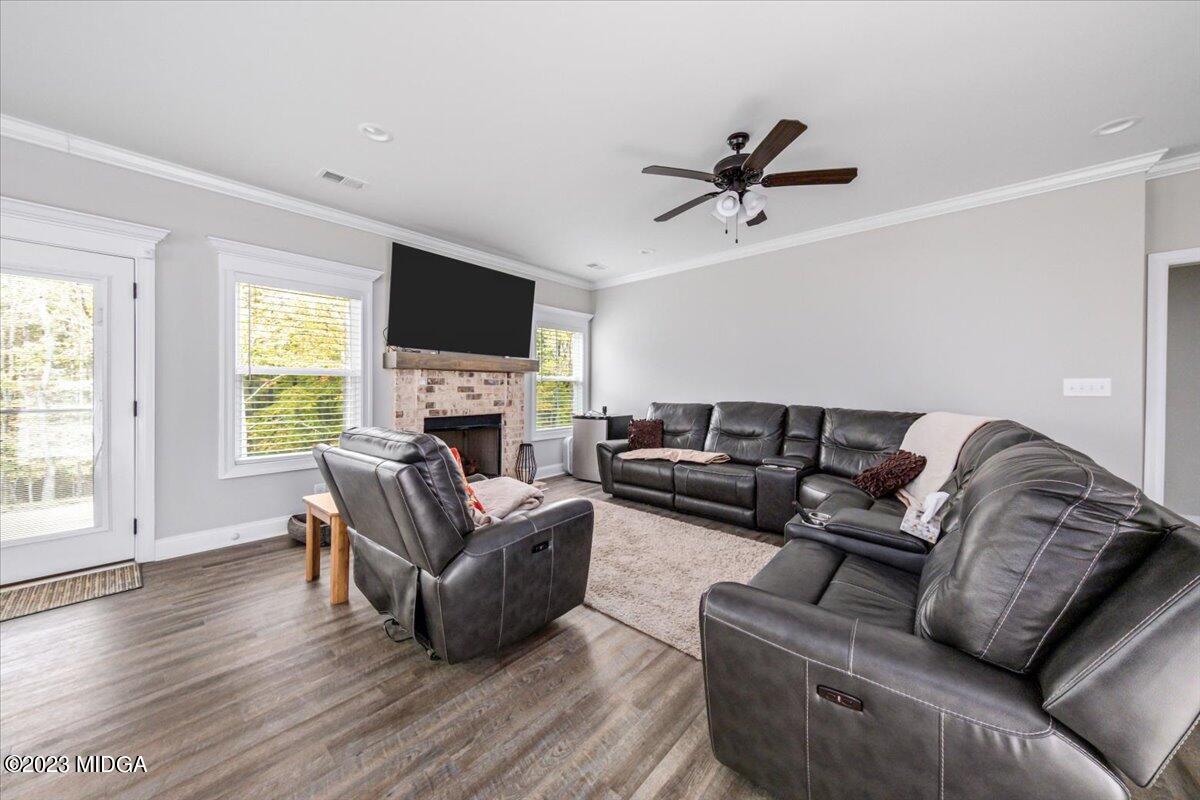 208 Carters Way Forsyth, GA 31029 - Photo 5 of 22 a living room with furniture a fireplace and a flat screen tv