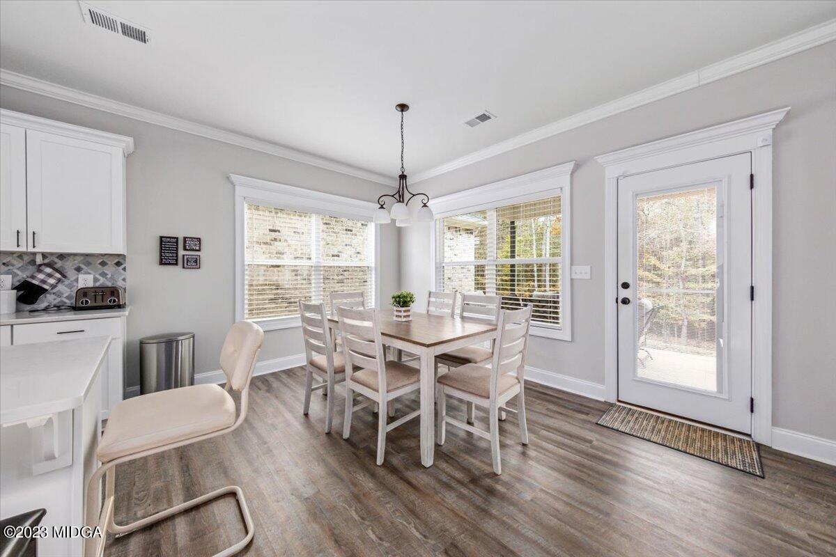208 Carters Way Forsyth, GA 31029 - Photo 10 of 22 a view of a dining room with furniture window and wooden floor