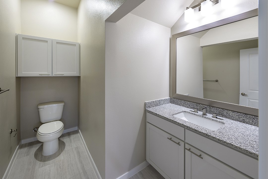 1724 Partnership Way, Unit 3101 Katy, TX 77449 - Photo 21 of 30 a bathroom with a granite countertop toilet and sink