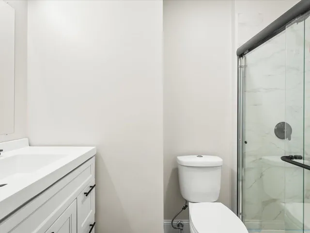 a bathroom with a sink a toilet and a shower