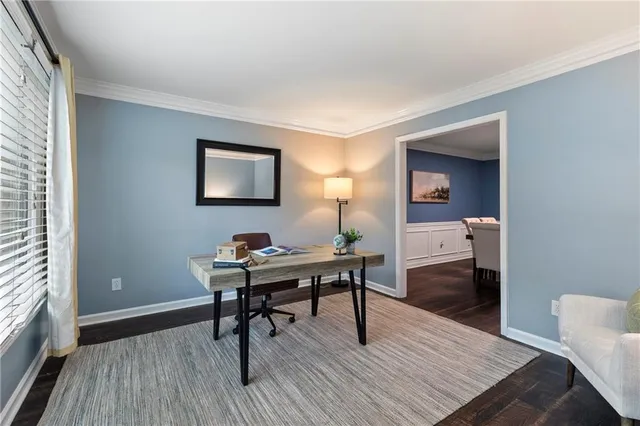a view of a workspace with furniture and wooden floor