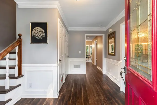 a hallway with wooden floor a chandelier